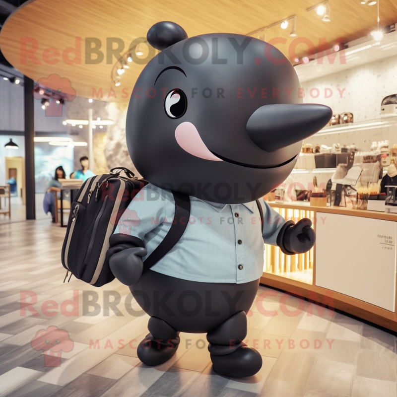 Black Whale mascot costume character dressed with a Chinos and Handbags