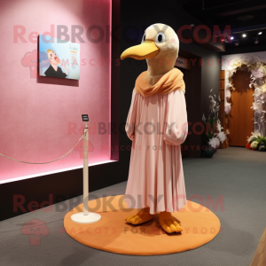 Peach Albatross mascot costume character dressed with a A-Line Dress and Shawl pins