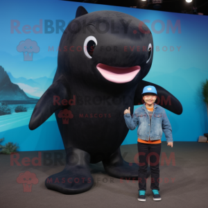 Black Whale mascot costume character dressed with a Jeans and Mittens