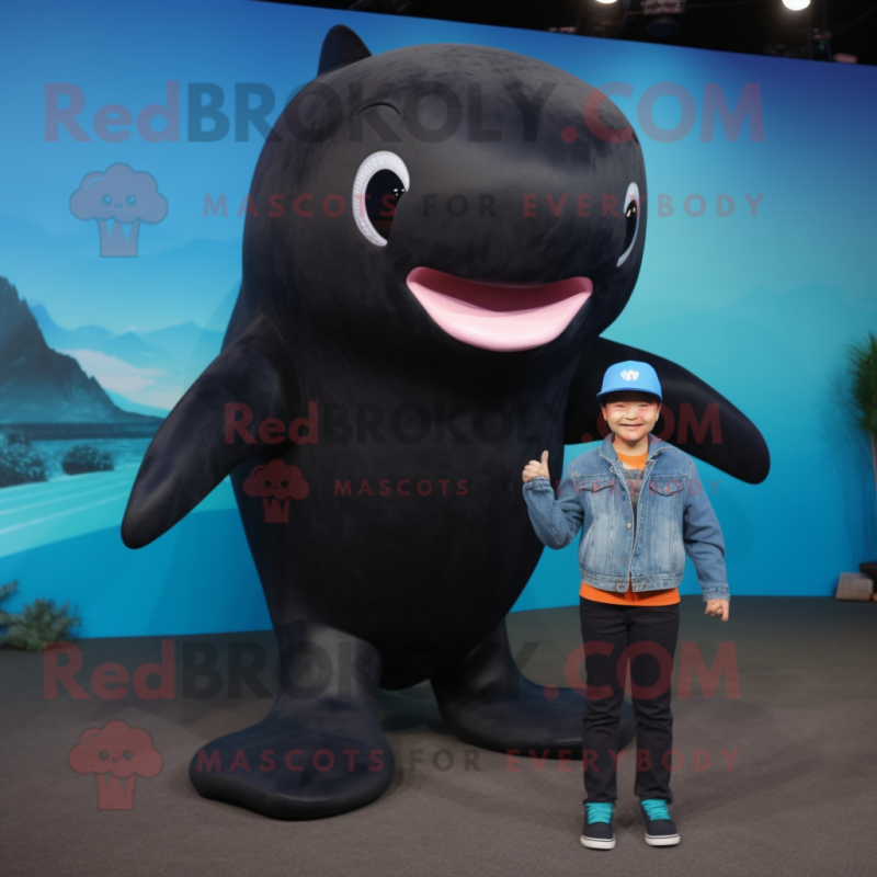Black Whale mascot costume character dressed with a Jeans and Mittens