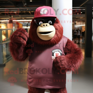 Maroon Gorilla mascot costume character dressed with a T-Shirt and Hat pins