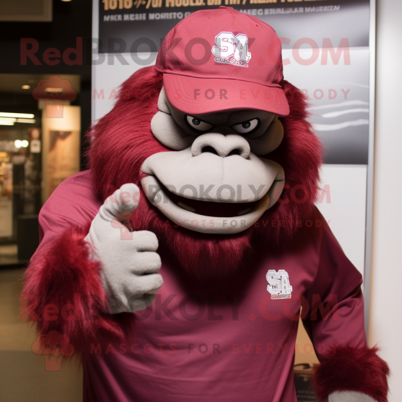 Maroon Gorilla mascot costume character dressed with a T-Shirt and Hat pins